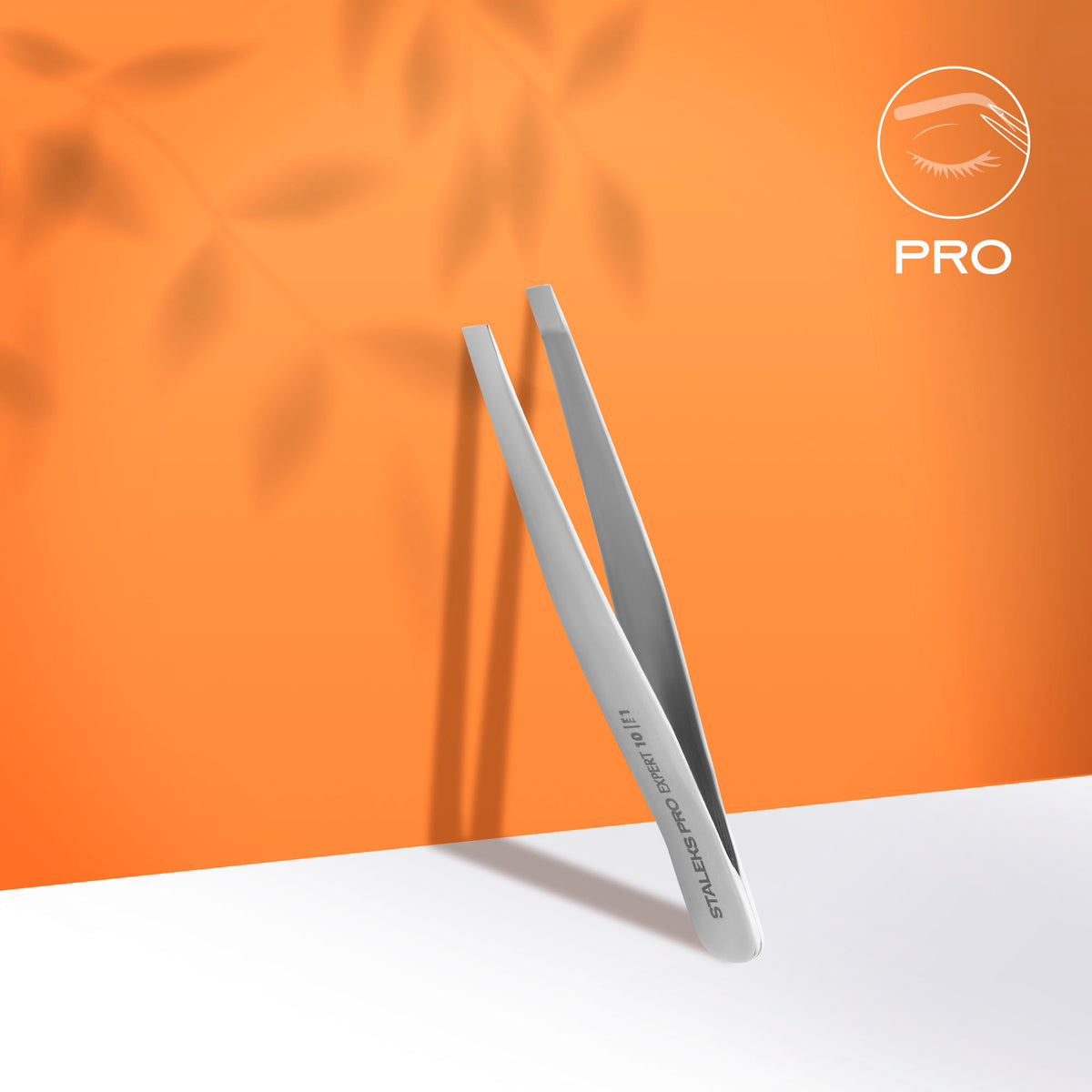 STALEKS TE-10/1 EXPERT eyebrow tweezers on orange background
